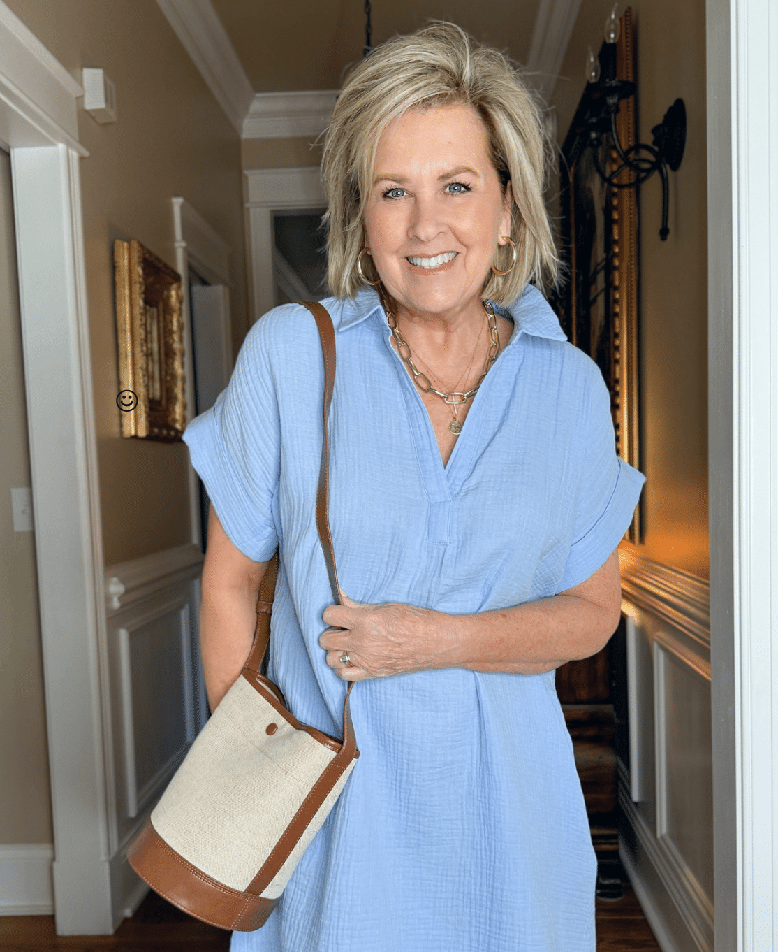 Tania Stephens is wearing a blue gauze dress and a linen bag from J.Crew Factory